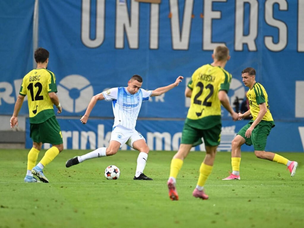 Universitatea Craiova avansează în turul 2 preliminar al UCL cu o victorie tardivă în fața lui ML Vitebsk "Universitatea Craiova Obține Victorie Tardivă și Avansează în Turul 2 Preliminar al UCL Împotriva ML Vitebsk"